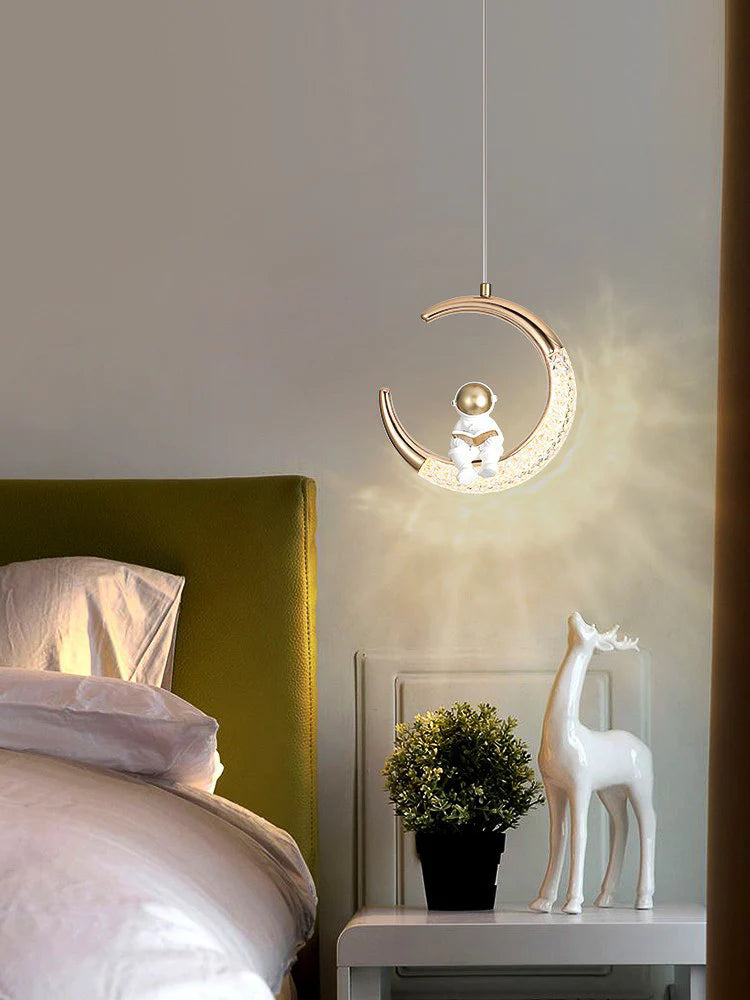 Astronaut Sitting on Illuminated Crescent Moon Pendant Light – Gold & White